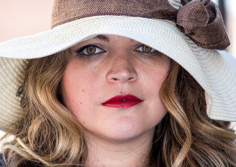 Beautiful woman with bright red lips in a hat