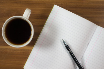 Planning - Blank paper with pen and cup of tea on wood background