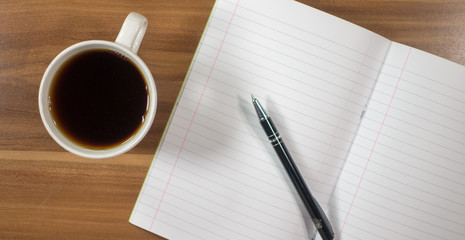 Planning - Blank paper with pen and cup of tea on wood background