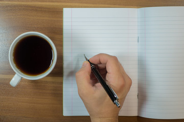 Planning - Blank paper with pen and cup of tea on wood background