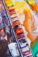 Abstract background concept for school watercolor. Hobbies and education, a cuvette with different watercolors. 