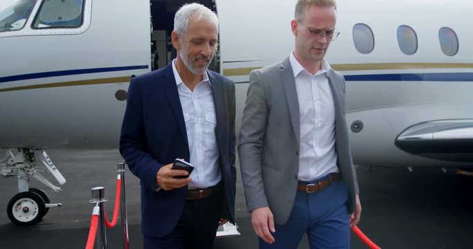 Business people leaving private jet 4k