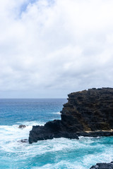 Volcanic shoreline cliffs and turquoise ocean on Oahu, Hawaii