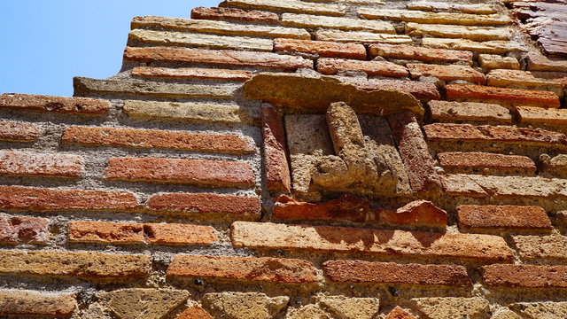 wall of pompei house with phallic symbol in the sun