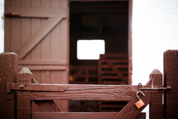 Wooden gates with unlocked padlock