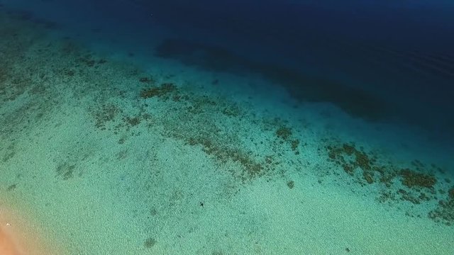 Aerial view of a man swimming alone on the paradisiacal beach on Koh Rok Yai.