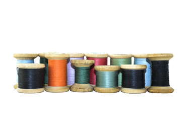 Reel or wood spool of sewing thread isolated on white.