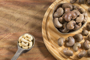 Cashew in a bowl on a dark wooden background - Anacardium occidentale