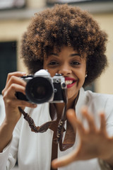 Female Photographer Holding an Old Analog Camera
