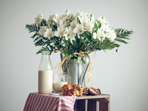 White flowers and tasty breakfast with muffins