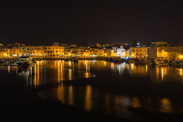 Fototapeta na wymiar Night view of Trani waterfront and port, Apulia, Italy