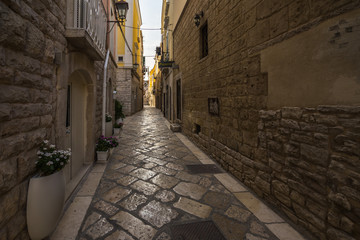 Fototapeta na wymiar A narrow typical street in the old town of Trani, Apulia, Italy