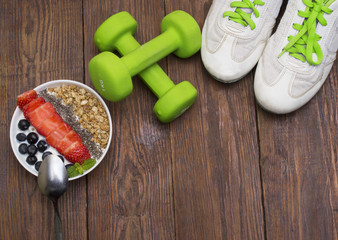 Dumbells, tape measure and healthy food. Fitness