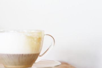 Cup of coffee with milk on wooden
