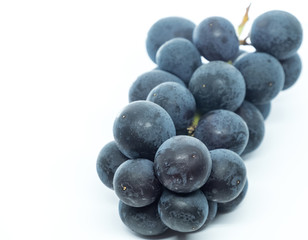 Black grape fruits over against white background