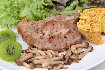 Homemade ,Pork steak  topped omelet with grilled mixed mushroom and mixed vegetable .