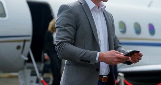 Businessman using mobile phone at terminal 4k