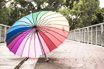 Rainbow umbrella on the floor in a park