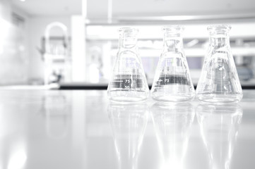 three glass flask in white clean chemistry science laboratory background