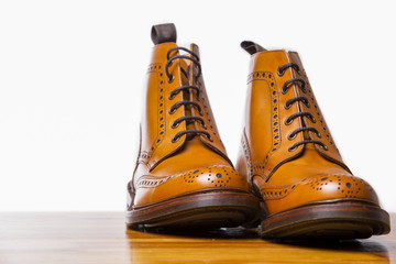 Footwear Concepts.Pair of High Gentleman Tanned Brogues Boots. Isolated Over White Background.