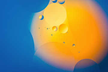 the interaction of water and oil, oil bubbles of various sizes on the water surface, colorful abstract macro background
