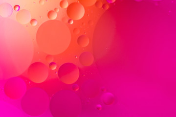 the interaction of water and oil, oil bubbles of various sizes on the water surface, colorful abstract macro background