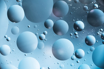 the interaction of water and oil, oil bubbles of various sizes on the water surface, colorful abstract macro background