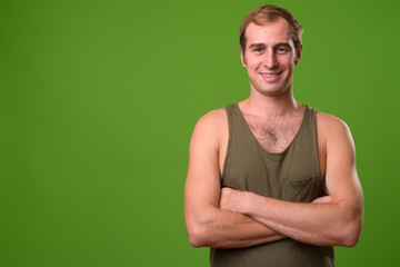 Young man against green background
