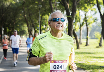 Mature runners running in a race - obrazy, fototapety, plakaty