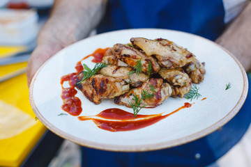 Chicken skewers on a plate with sauce