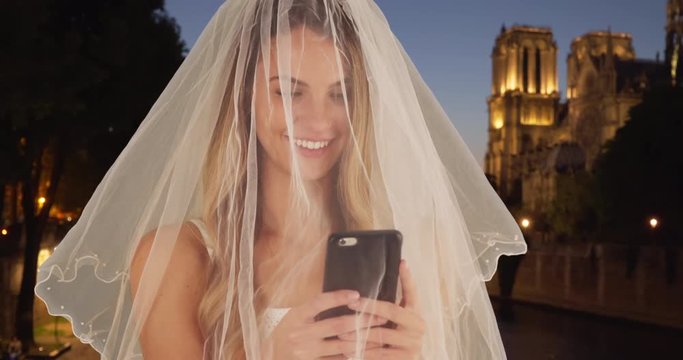 Gorgeous bride taking a selfie in Paris, Woman wearing traditional veil taking picture with mobile phone smiling, 4k