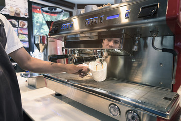 Barista made drink by coffee machine with vintage tone.