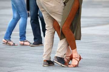 Feet of dancing couples on the street