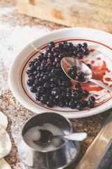 plate with black round berries is on table