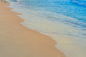 Fototapeta na wymiar Beach waves on sand day time