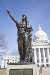 State capitol building in Madison, Wisconsin with womens memorial statue