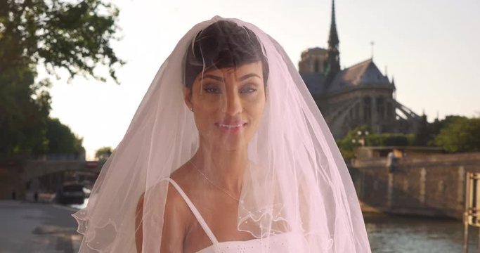 Blushing elegant bride in Paris, France poses for portrait, Black woman in traditional wedding veil cheerful and excited, smiling at camera, 4k