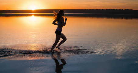 Woman Running on the Beach at Sunset.