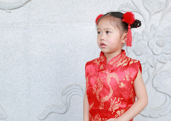 Portrait face of little asian girl in cheongsam on traditional chinese new year festival.