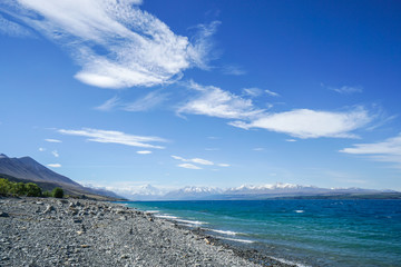 coastline with deep blue sea with Mount Cook backdrop in New Zealand