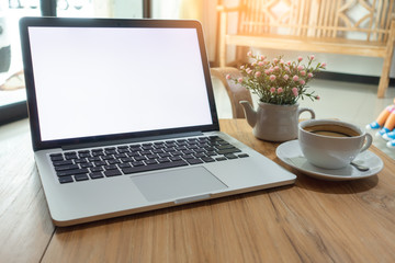  Wood office desk tablewith eye glasses,laptop,smart phone and cup of coffee.Top view with copy space.