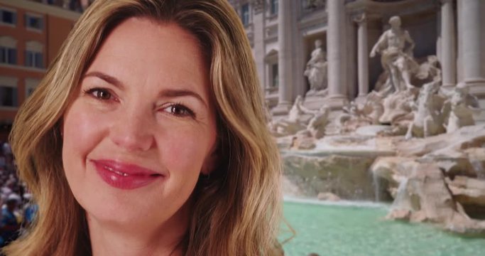 Close up portrait of joyful woman tourist in Rome, Caucasian woman at the Trevi Fountain laughing and smiling, 4k