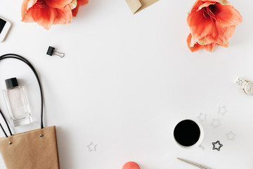 Frame flowers amaryllis paper hand bag smartphone perfume cup coffee white background Flat lay top view Shopping background