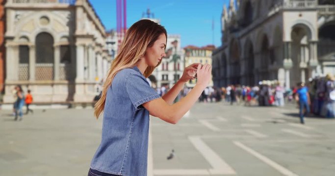 Happy woman tourist taking picture in San Marco Piazza, Smiling female takes photo of summer vacation in Venice, 4k