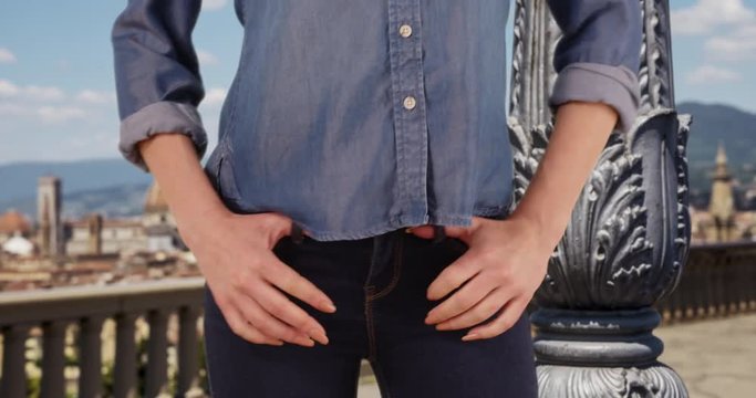 Caucasian woman in Florence, Italy wearing blue jeans, Close up of slender female posing in pair of denims outside, 4k