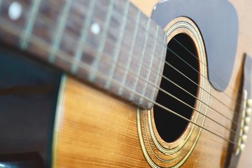 Obraz premium Close up of old Acoustic Guitar with very shallow depth of field, focus on strings.