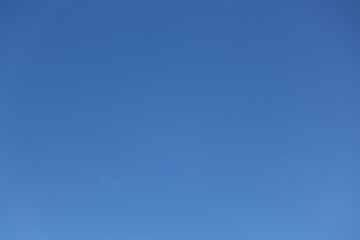 Sky, clear blue sky background with clouds and space in the middle.