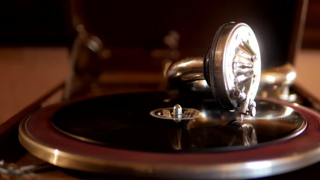 Old retro gramophone with vinyl works on the table