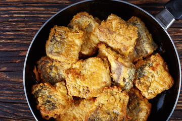 fried pieces of hake on a skillet