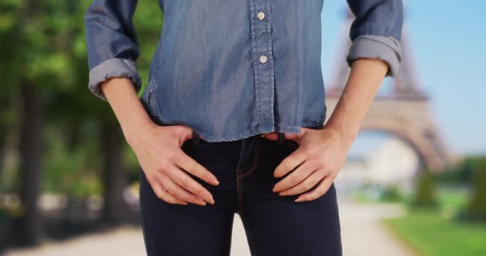 Woman in Paris, France posing in blue jeans, Slender female wears denim jeans outside, 4k